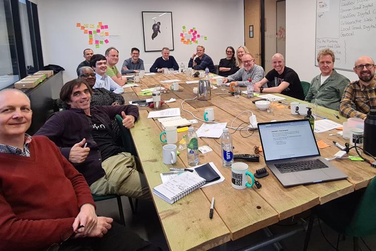 LocalGov Drupal awayday group photo of people sitting round a large table