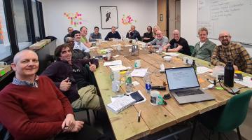 LocalGov Drupal awayday group photo of people sitting round a large table